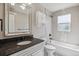 Modern bathroom features updated fixtures, stylish tile, and a shower-tub combination at 765 Iola St, Aurora, CO 80010