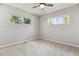 Bright bedroom with neutral carpet and large windows offering natural light and outdoor views at 765 Iola St, Aurora, CO 80010