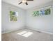 Cozy bedroom with a ceiling fan, neutral carpet, and large windows offering natural light at 765 Iola St, Aurora, CO 80010