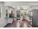 Modern kitchen featuring white cabinets, stainless steel appliances, granite countertops, and stylish lighting at 765 Iola St, Aurora, CO 80010