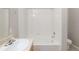 Clean bathroom featuring a tiled tub/shower combo and a pristine white sink at 8358 S Independence # 107, Littleton, CO 80128