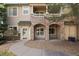 Charming condo featuring stone accents, a covered porch, and well-maintained landscaping at 8358 S Independence # 107, Littleton, CO 80128
