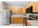 Bright kitchen featuring stainless steel appliances, light wood cabinets, and white countertops at 8358 S Independence # 107, Littleton, CO 80128