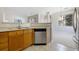Corner view of the kitchen featuring a stainless steel dishwasher with an open view to the dining area at 8358 S Independence # 107, Littleton, CO 80128