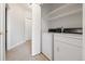 Bright laundry room with white washer and dryer and ample storage space at 8358 S Independence # 107, Littleton, CO 80128
