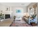 Bright living room with a fireplace, large window, and contemporary decor at 8358 S Independence # 107, Littleton, CO 80128