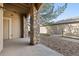 Covered outdoor patio showing stone supports and access to a pebbled yard at 8358 S Independence # 107, Littleton, CO 80128