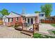 Backyard with patio and dining set, wooden deck, gravel area, and grass, perfect for outdoor entertaining at 2301 E Yale Ave, Denver, CO 80210