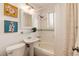 Classic bathroom with pedestal sink, tiled shower, and decorative accents at 2301 E Yale Ave, Denver, CO 80210