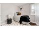Bright bedroom featuring wood floors, a patterned rug, and decorative wall art at 2301 E Yale Ave, Denver, CO 80210