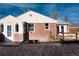 Charming brick home featuring a well-kept exterior and a cozy entrance with a small deck at 2301 E Yale Ave, Denver, CO 80210