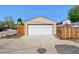 Detached garage with a modern white door, offering secure parking and storage space at 2301 E Yale Ave, Denver, CO 80210