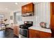 Well-equipped kitchen with stainless steel appliances, modern tile backsplash, and ample cabinet space at 2301 E Yale Ave, Denver, CO 80210