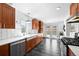 Beautiful kitchen features stone tile floor, wooden cabinets, stainless appliances, and white subway tile backsplash at 2301 E Yale Ave, Denver, CO 80210