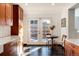 Bright kitchen featuring white countertops, wood cabinets, and direct access to the backyard at 2301 E Yale Ave, Denver, CO 80210