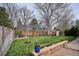 A large, well-maintained backyard with green grass, a wooden fence, and a brick patio area at 7343 S Ivy Way, Centennial, CO 80112