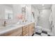 A bathroom with a double vanity, modern fixtures, and a walk-in shower, combines style and functionality at 7343 S Ivy Way, Centennial, CO 80112