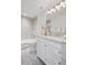 Bright bathroom featuring white marble countertops and cabinetry complemented by updated fixtures at 7343 S Ivy Way, Centennial, CO 80112