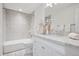Well-lit bathroom features white marble countertops and cabinetry complemented by updated fixtures at 7343 S Ivy Way, Centennial, CO 80112