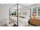 Cozy bedroom featuring a four-poster bed, neutral tones, and natural light creates a relaxing atmosphere at 7343 S Ivy Way, Centennial, CO 80112