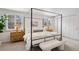 A serene bedroom features a four-poster bed and soft decor, creating a peaceful retreat at 7343 S Ivy Way, Centennial, CO 80112