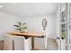 Bright dining room with a stylish wooden table, comfortable seating, and modern decor at 7343 S Ivy Way, Centennial, CO 80112