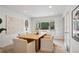Elegant dining room featuring a modern table, six chairs, and ample natural light at 7343 S Ivy Way, Centennial, CO 80112