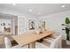 Bright dining room featuring a large table, six chairs, and modern decor at 7343 S Ivy Way, Centennial, CO 80112