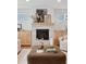 Close-up of the modern fireplace with stone surround and decorative mantle at 7343 S Ivy Way, Centennial, CO 80112