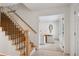 Elegant foyer featuring a wooden staircase, tile flooring, and an open view to the dining room at 7343 S Ivy Way, Centennial, CO 80112