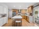 Bright kitchen featuring stainless appliances, a spacious island, and hardwood floors at 7343 S Ivy Way, Centennial, CO 80112
