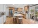 Kitchen with stainless steel appliances, modern island, and hardwood flooring at 7343 S Ivy Way, Centennial, CO 80112