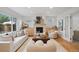 Bright living room featuring a modern fireplace, hardwood floors, and stylish decor at 7343 S Ivy Way, Centennial, CO 80112