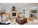 Living room featuring fireplace, hardwood floors, and a view into the dining room at 7343 S Ivy Way, Centennial, CO 80112