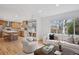 Open floorplan: living room flows into kitchen with breakfast bar seating at 7343 S Ivy Way, Centennial, CO 80112
