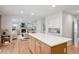 Open floorplan with kitchen island and living area with fireplace at 7343 S Ivy Way, Centennial, CO 80112