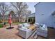 Outdoor living space with wicker sofas and chairs on a brick patio at 7343 S Ivy Way, Centennial, CO 80112