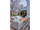 Covered patio dining and outdoor seating area with wicker furniture on a brick patio at 7343 S Ivy Way, Centennial, CO 80112