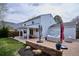 Covered patio with outdoor seating, brick hardscape, and views of the backyard at 7343 S Ivy Way, Centennial, CO 80112