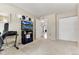 View of the bedroom with closet, TV, snowboard and an open entry to another room at 1201 Galapago St # 109, Denver, CO 80204