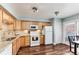 Bright kitchen featuring wood cabinets, granite countertops, and stainless steel appliances at 1201 Galapago St # 109, Denver, CO 80204