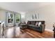 Bright living room boasts hardwood floors, a comfortable couch, large windows and serene decor at 1201 Galapago St # 109, Denver, CO 80204
