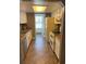 Efficient galley kitchen featuring white cabinets, neutral countertops, and modern appliances at 4663 S Fraser Ct # C, Aurora, CO 80015
