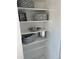 Well-organized linen closet with multiple shelves and decorative storage boxes at 4663 S Fraser Ct # C, Aurora, CO 80015