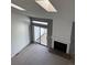 A look at the living room featuring a fireplace, sliding glass door, and skylights at 4663 S Fraser Ct # C, Aurora, CO 80015