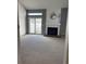 Spacious living room features a fireplace, large sliding glass doors, and neutral carpeting at 4663 S Fraser Ct # C, Aurora, CO 80015