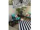 Cozy patio area with stylish outdoor furniture, striped umbrella, and decorative accents at 4663 S Fraser Ct # C, Aurora, CO 80015