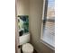 Powder room features updated fixtures, a bright window and modern decor at 4663 S Fraser Ct # C, Aurora, CO 80015