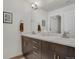Modern bathroom features dual sinks, wood cabinets, and a large mirror at 11440 E Martin Luther King Jr Blvd, Denver, CO 80238