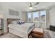 Bright bedroom features a large bed, wood headboard, large windows, and an ottoman at 11440 E Martin Luther King Jr Blvd, Denver, CO 80238